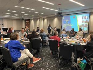 Boo and several other people in a meeting for the school board