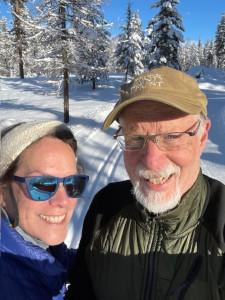 Boo and her husband out in the snow on a ski trail